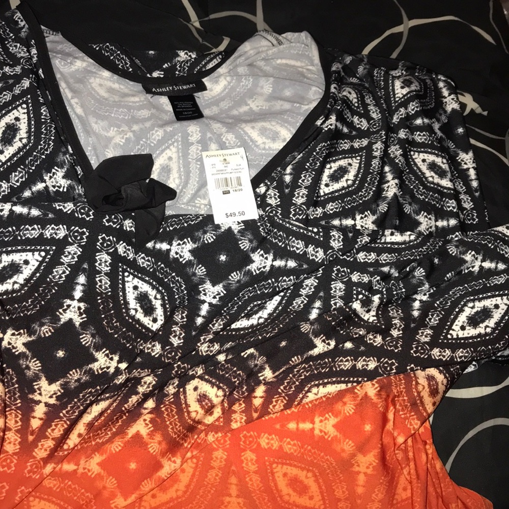 black dress with white designs and orange bottom